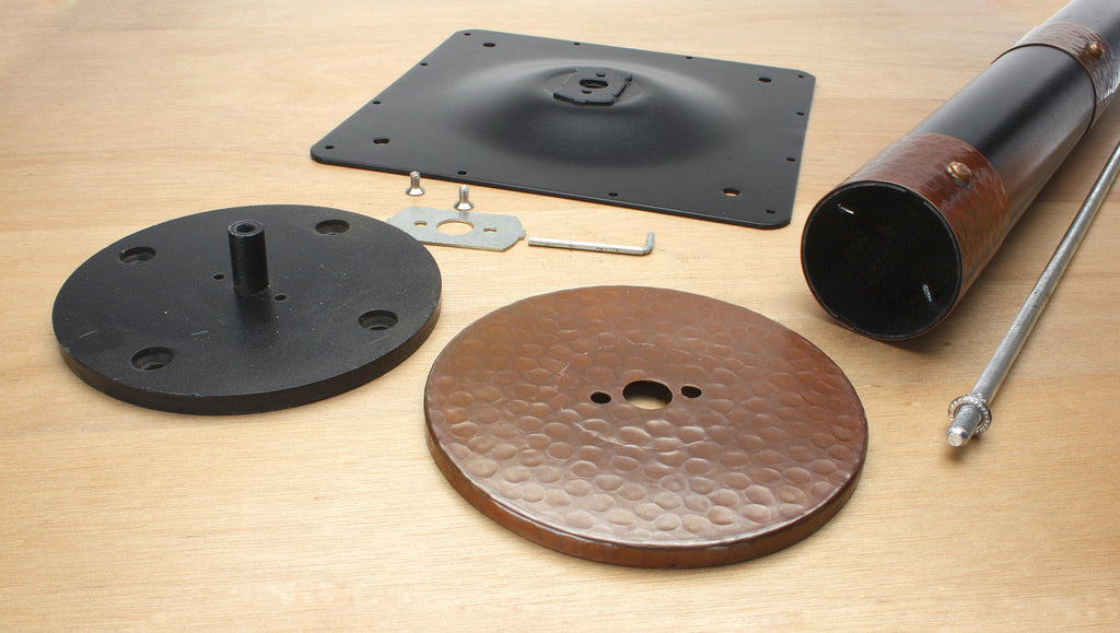 Components of Copper Eclipse Bolt Down Base including column, spider, cover, mounting plate and hardware.